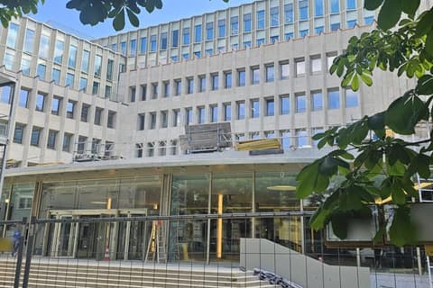 Administrative building with glazed entrance during construction work