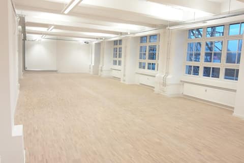 White commercial floor with parquet flooring and multi-pane windows