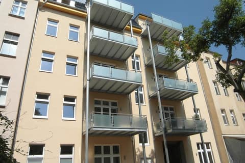 Courtyard façade of a period building with new steel balconies and glass balustrades